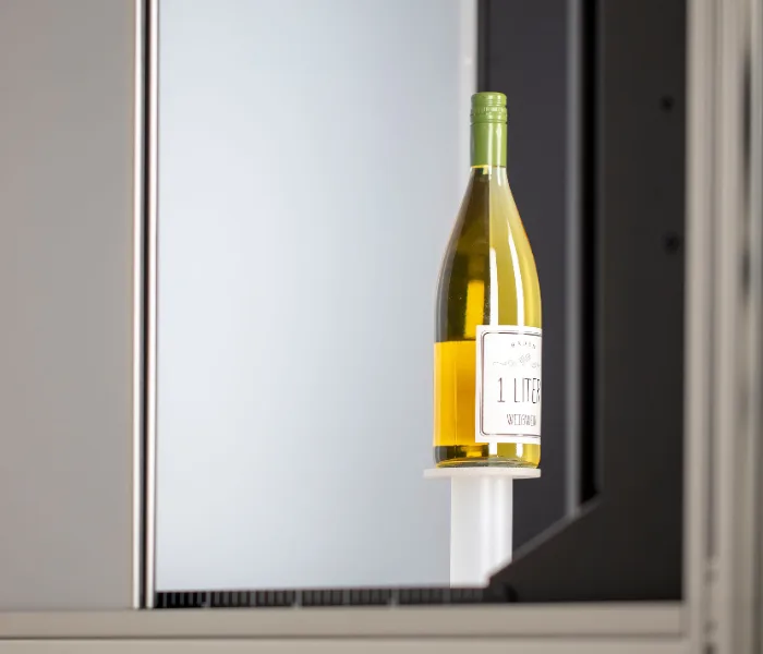 Wine bottle mounted on the bottle support inside an Orbitvu studio