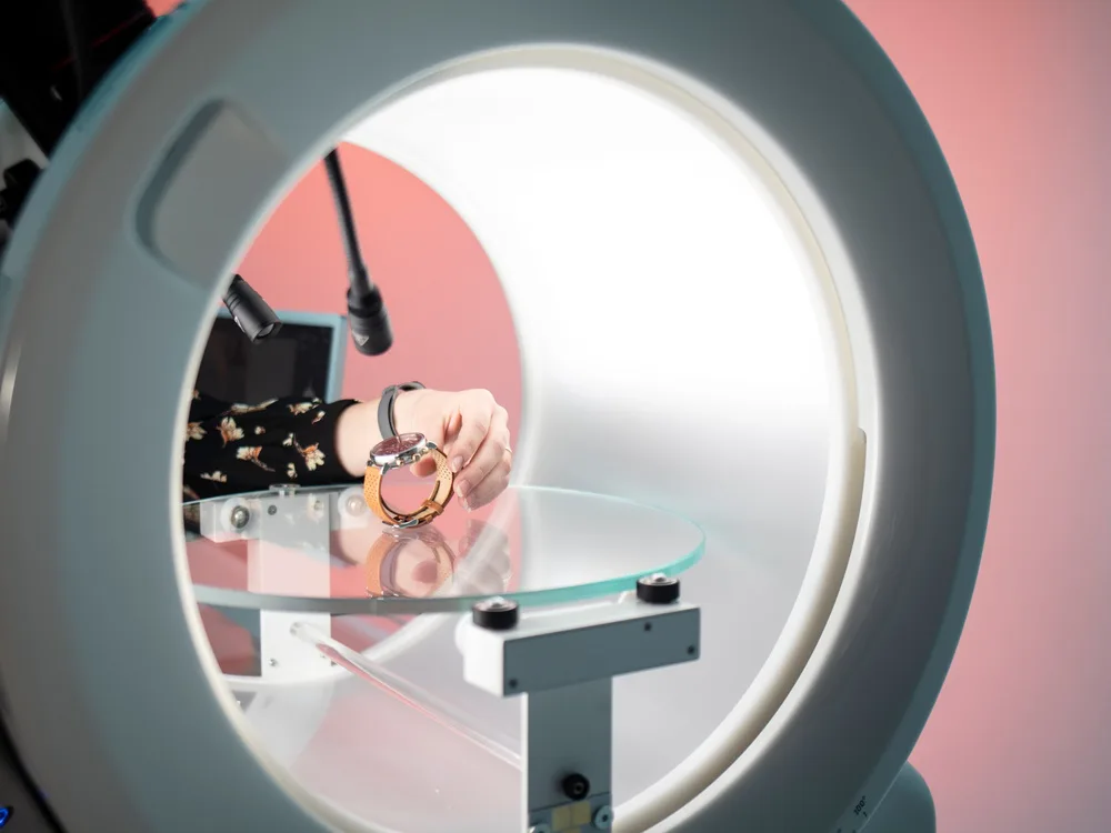 Watch being placed in Alphashot Micro V2 under complex lighting