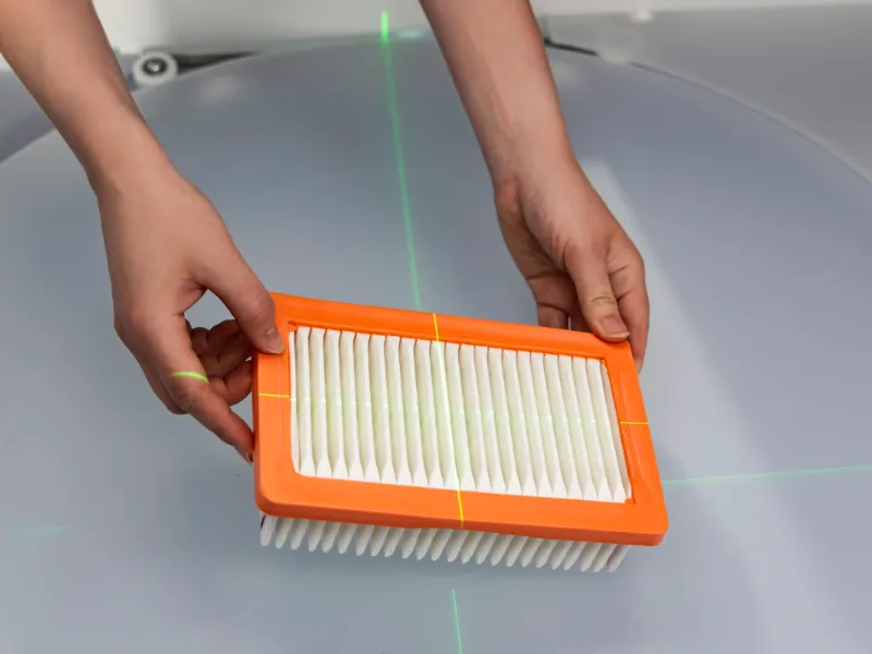 Placing a car air filter on the motorized turntable with laser guide