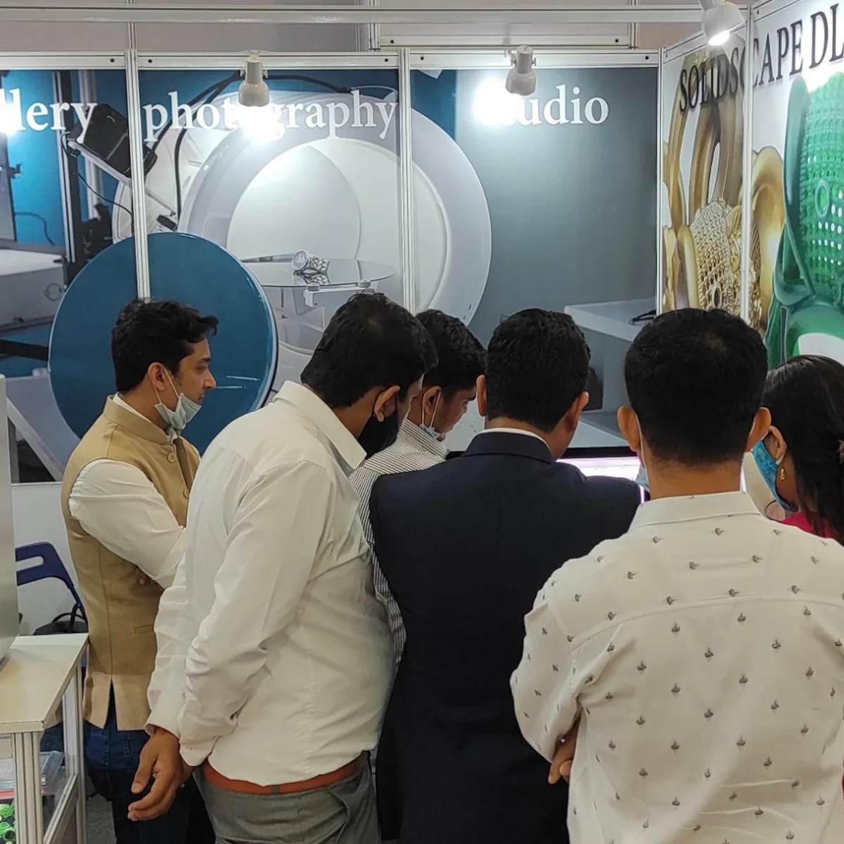 Team demonstrating Alphashot Micro V2 to visitors