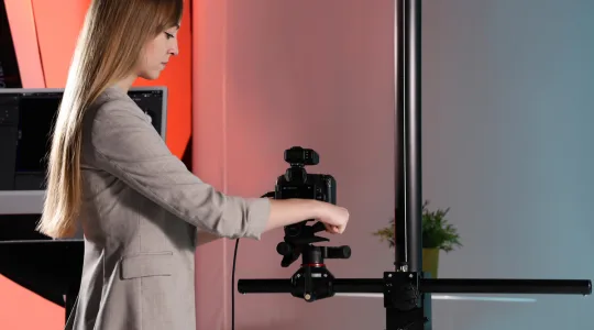 Operator adjusting a camera on the column stand